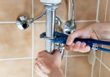 plumber repairing the bathroom plumbing in an Illinois home